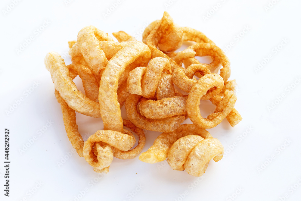 Fried crispy pork rinds on white background. Fried crispy pork rinds on white background.