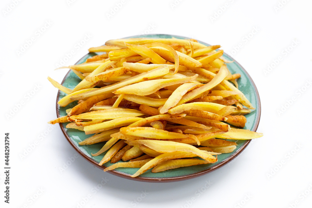 Sliced finger root in plate on white background. Sliced finger root in plate on white background.