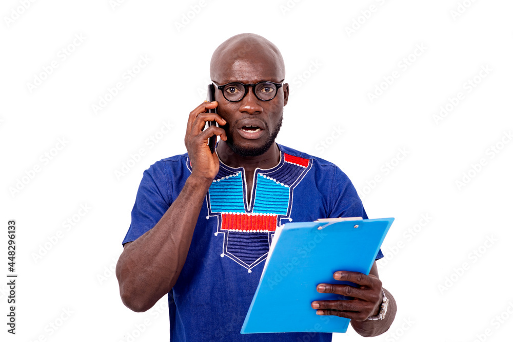 astonished businessman talking on mobile phone while checking contract on clipboard. astonished businessman talking on mobile phone while checking contract on clipboard.