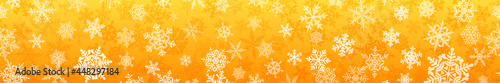 Banner of complex Christmas snowflakes with seamless horizontal repetition, in yellow colors. Winter background with falling snow