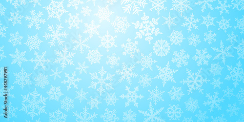 Christmas background with various complex big and small snowflakes in light blue colors