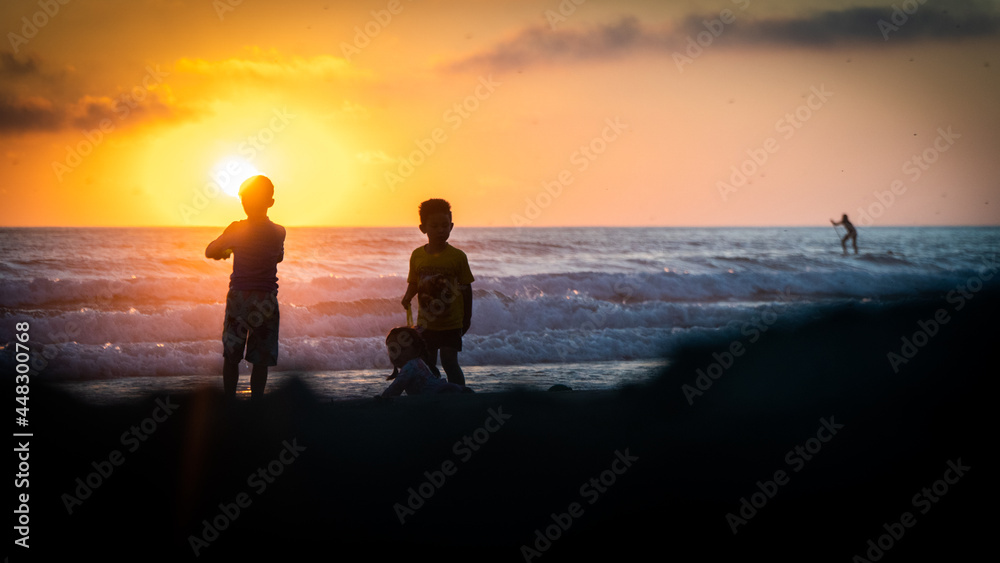 silhouette of a couple walking on the beach