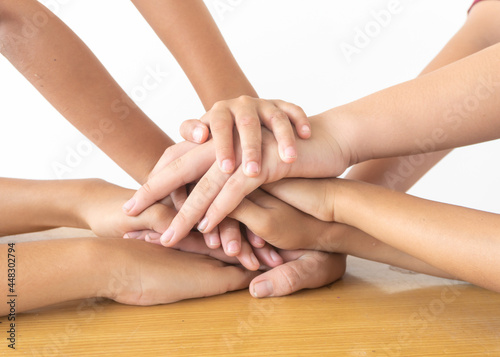People with joined hands as a team together. Concept of team building