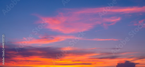 Beautiful Vivid sky painted by the sun leaving bright golden shades.Dense clouds in twilight sky in winter evening.Image of cloud sky on evening time.Evening Vivid sky with clouds. © Chalermwoot