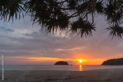 scenery red sky the sun down to the sea..beautiful red sky at sunset in Kata beach Phuket Thailand.high quality image for travel concept. red sky background..