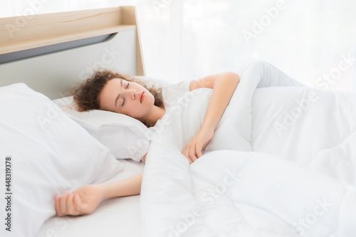 Caucasian young woman sleeping in bed.
