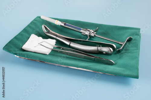  Dentistry medical tools forcept on blue background. photo