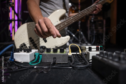 Close-up set of distortion effect pedals for guitar on stage.