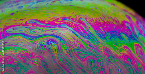 Abstract colourful background with patterns and rainbow effects in soap bubbles. 