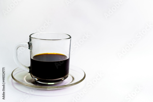black coffee in a clear glass on a white background