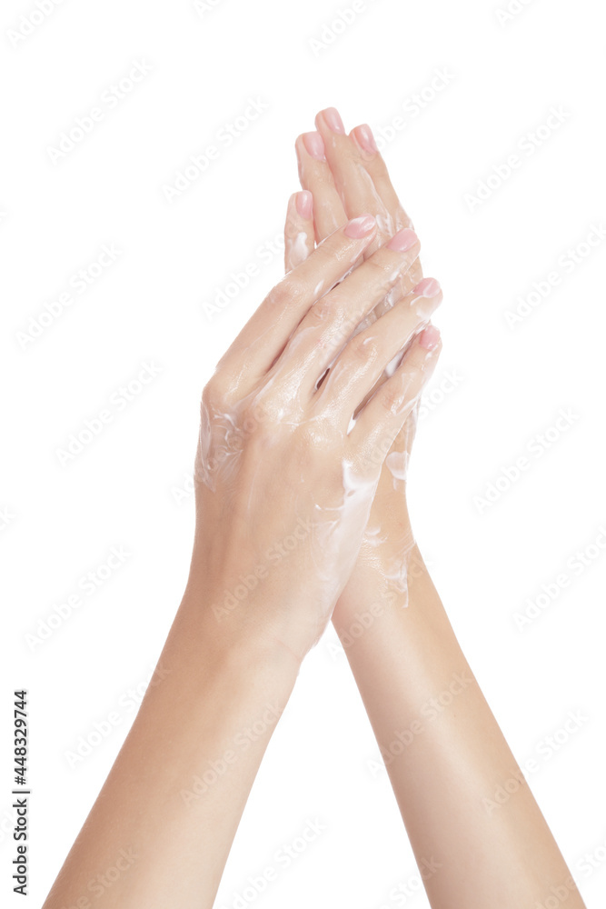 Female hands isolated on white background. Moisturizing hands with cream. Applying the cream to the skin Female hands isolated on white background. Moisturizing hands with cream. Applying the cream to the skin