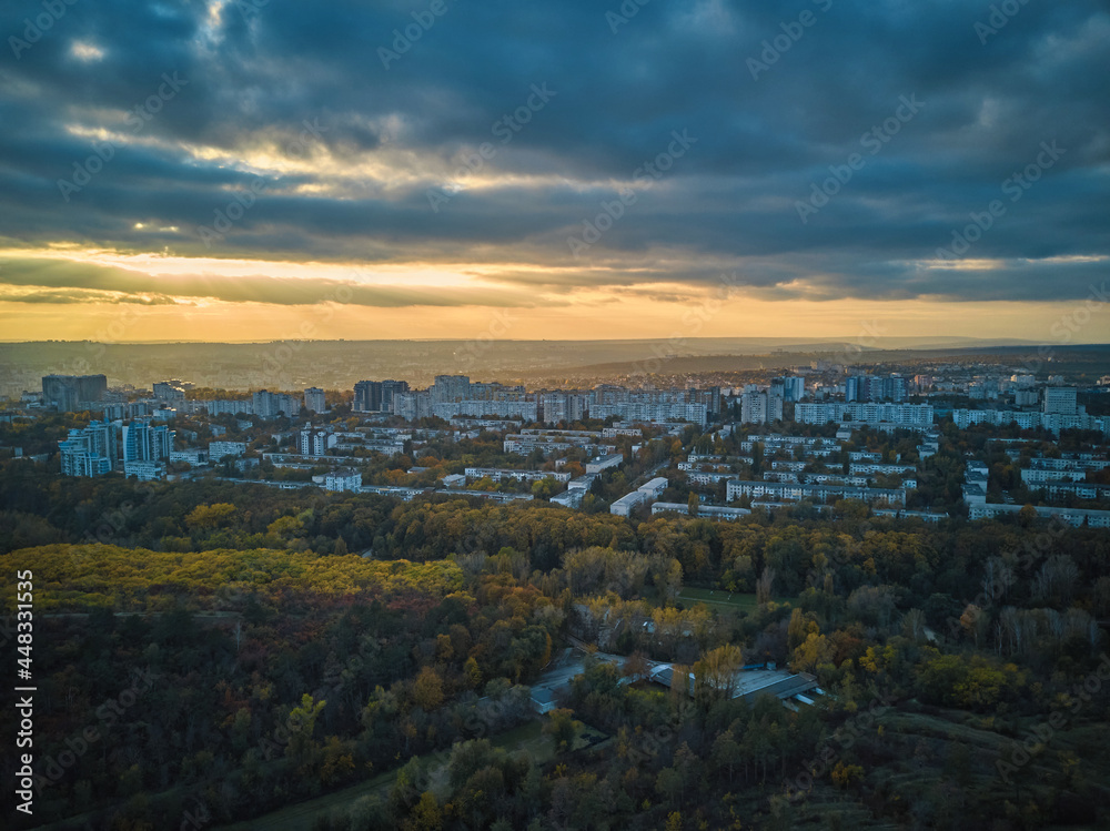 Aerial over the city in autumn at sunset.