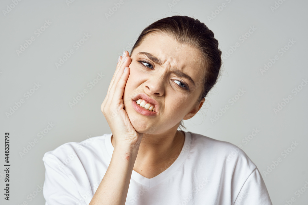 woman holding her head stress emotions discomfort pain close-up woman holding her head stress emotions discomfort pain close-up