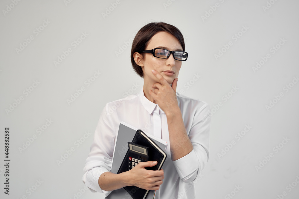 woman in white shirt with documents glasses official
