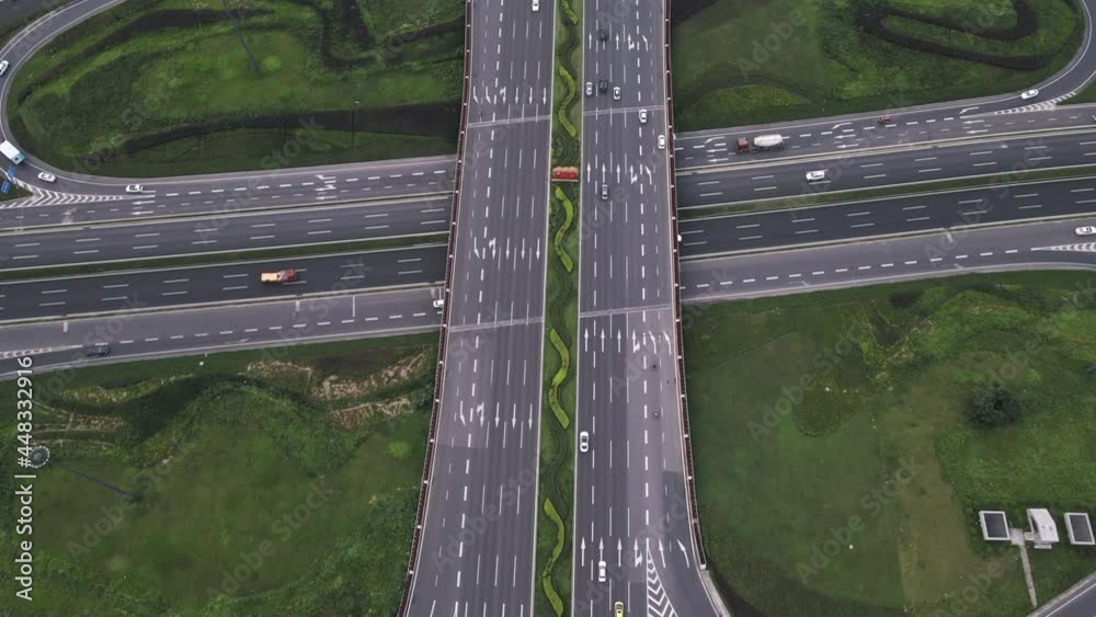 Zoom out drone aerial of modern clover leaf shaped multilevel asphalt
