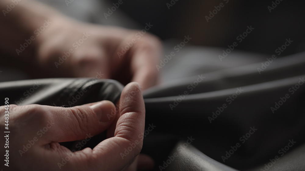 Closeup man touching fine leather