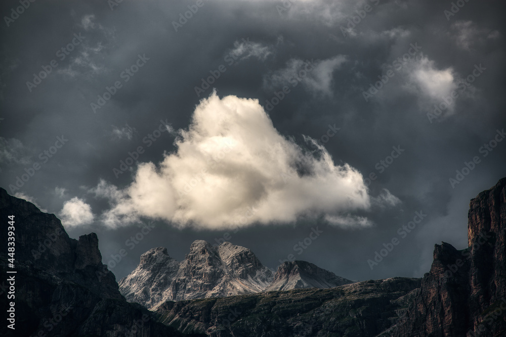 White cloud illuminated by the sun over the top of the mountains during the storm White cloud illuminated by the sun over the top of the mountains during the storm