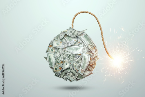 Obraz na plátně Bomb from money banknotes with a burning wick against white background