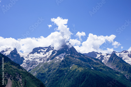 mountain peaks with snow lying in the summer. Dombay, July 2021 © Яна Айбазова