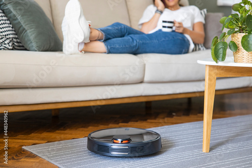 Robot vacuum cleaner cleaning the living room.
