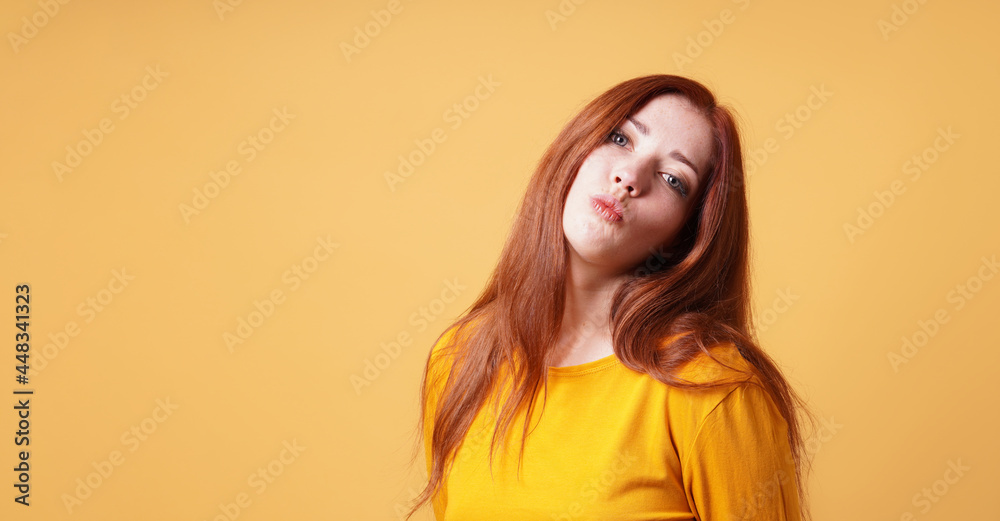 young woman making funny face with pursed lips for kiss or duckf young woman making funny face with pursed lips for kiss or duckf