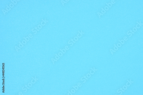 Solid blue paper background and texture for your text and design.