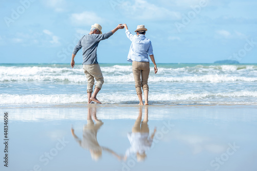 Retirement Travel. Asian Lifestyle senior couple dancing on the beach happy and relax time.  Tourism elderly family travel leisure and activity after retirement in vacations and summer.