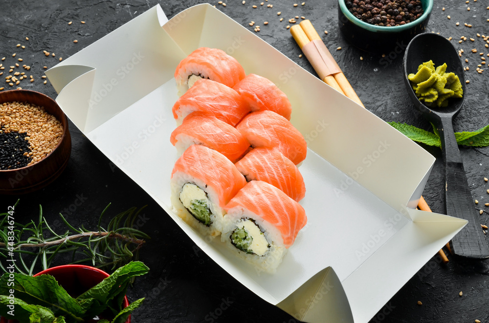 Sushi rolls with salmon, cucumber and Philadelphia cheese. Japanese food. Traditional sushi. Top view. Sushi rolls with salmon, cucumber and Philadelphia cheese. Japanese food. Traditional sushi. Top view.