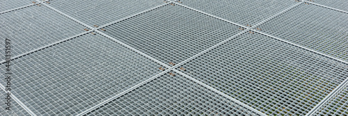 Metal panoramic background. Grating platform. Square industrial galvanized metal grid