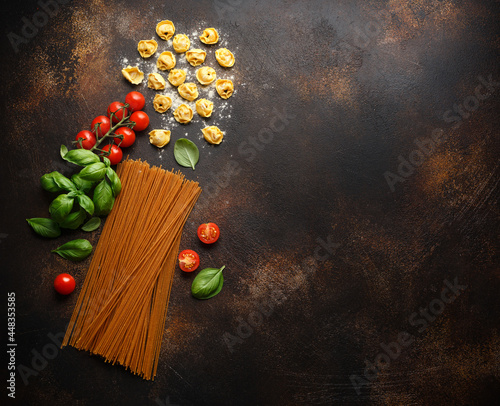 Italian healthy food ingredients ready for cooking. Ravioli, spaghetti, cherry tomatoes, basil