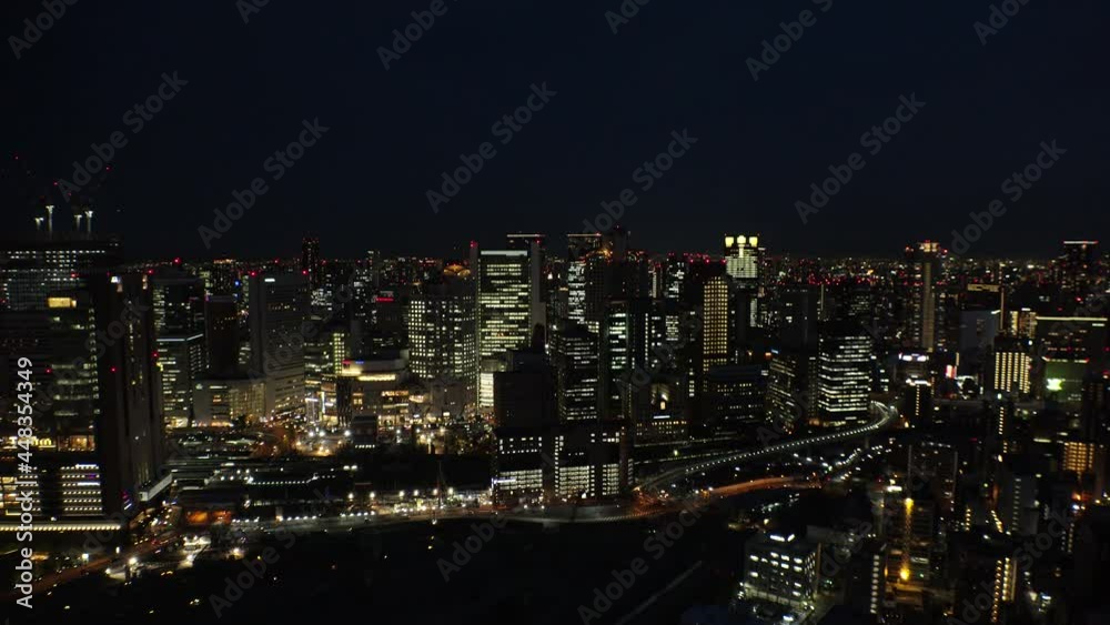 UMEDA, OSAKA, JAPAN : Aerial high angle view of CITYSCAPE of OSAKA at night. View of buildings and street around Osaka and Umeda station. Wide view real time shot. UMEDA, OSAKA, JAPAN : Aerial high angle view of CITYSCAPE of OSAKA at night. View of buildings and street around Osaka and Umeda station. Wide view real time shot.