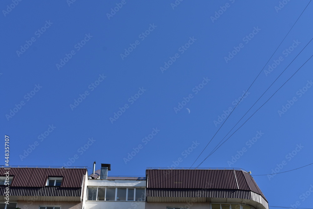 Street landscape. Houses in the city and moon in the sky Street landscape. Houses in the city and moon in the sky