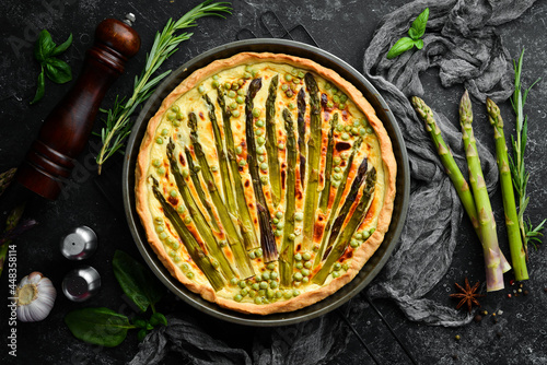 Puff pastry tart with asparagus and spices. Healthy food. Top view. Free space for your text.