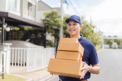 Delivery man holding cardboard boxes to customer home.  Fast and free Delivery transport . Online shopping and Express delivery . © chompoo
