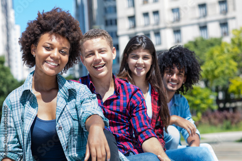 African american woman with group of multicultural young adults in a row