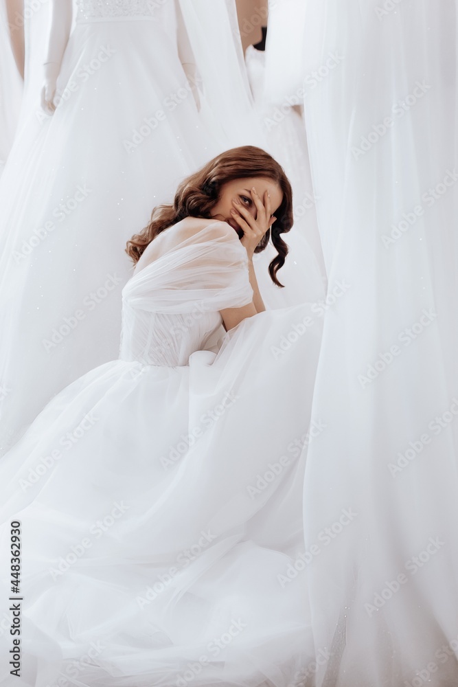 Beautiful brunette bride with light make-up in white dress in an exquisite interior. Best day of life. Beautiful brunette bride with light make-up in white dress in an exquisite interior. Best day of life.