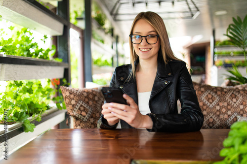 Woman use of smart phone in coffee shop