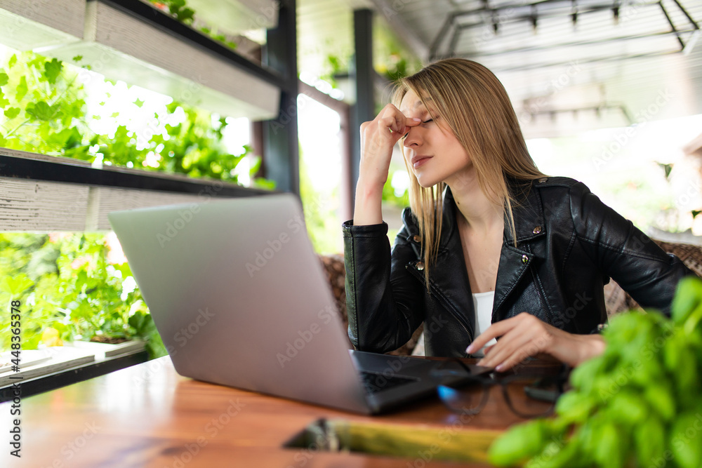 Freelance woman headache tired, stess or deadline with digital laptop working on workplace in coffee shop. Freelance woman headache tired, stess or deadline with digital laptop working on workplace in coffee shop.