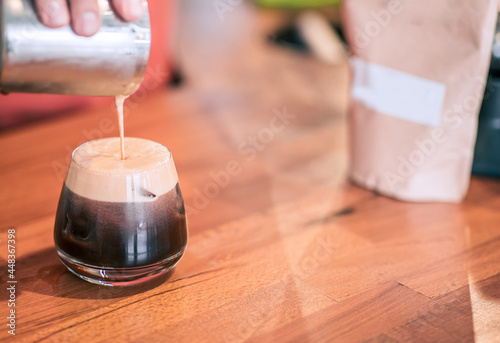 Barista is prepring a cold brew in a vintage designed coffee shop. Closeup detail view with copyspace. photo