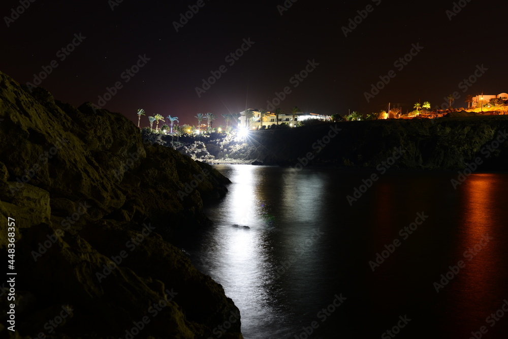 sea against the background of night city lights