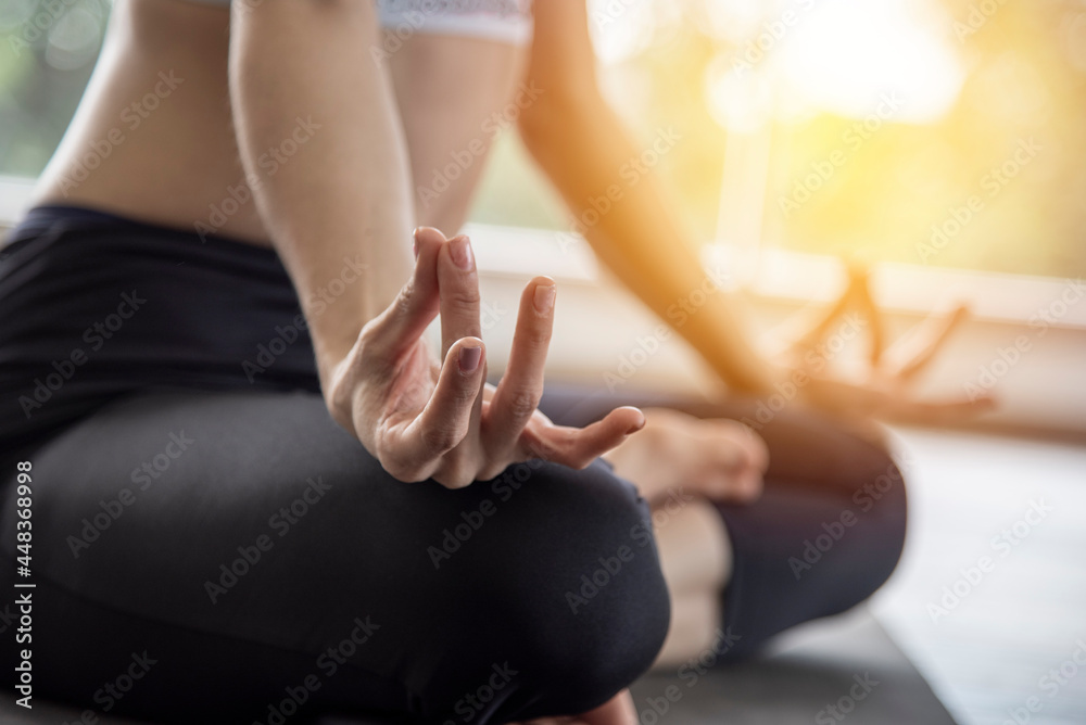 Yoga woman sits on a asana in her room calmly and relaxes. light and comfortable in the morning home workout ideas health care