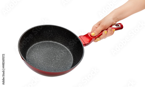 Woman's hand holding frying pan with non-stick coating. Isolated on white.
