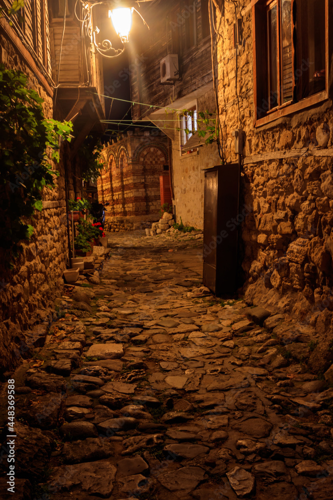 Fototapeta premium Narrow street of old town of Nessebar in Bulgaria at night