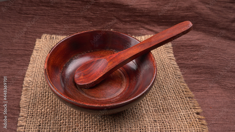 Empty wooden bowl and wooden spoon isolated with copy space. Empty wooden bowl and wooden spoon isolated with copy space.