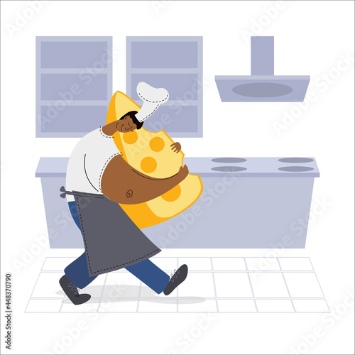 Dark skinned chef holding a piece of cheese in the kitchen