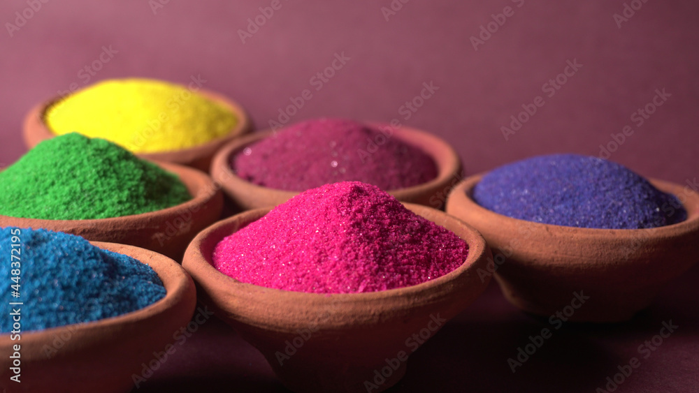 Diwali Festival showing Colourful rangoli in bowls,clay lamp or diya on background Diwali Festival showing Colourful rangoli in bowls,clay lamp or diya on background