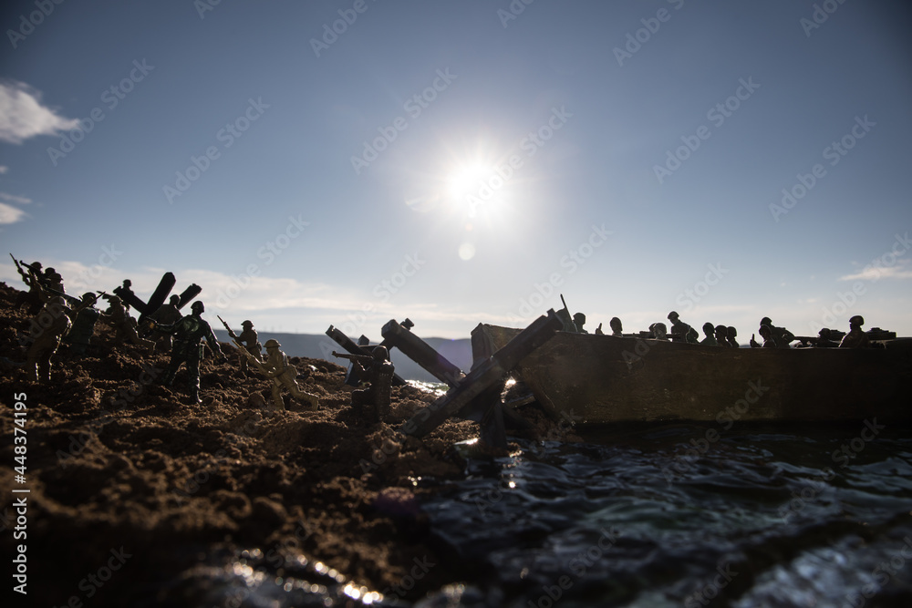 Fototapeta premium World War 2 reenactment (D-day). Creative decoration with toy soldiers, landing crafts and hedgehogs. Battle scene of Normandy landing on June 6, 1944.