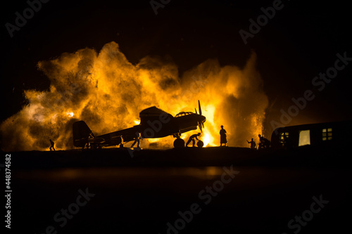 German Junker (Ju-88) night bomber at night. Artwork decoration with scale model of jet-propelled plane in possession. Toned foggy background with light. War scene.