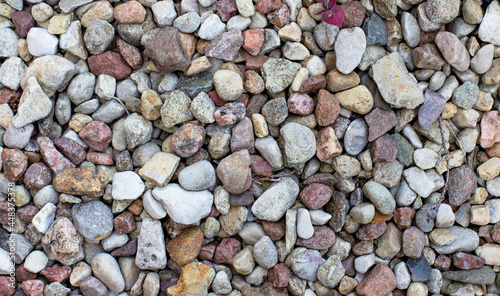 Abstract background with multicolored small pebble stones of different shapes