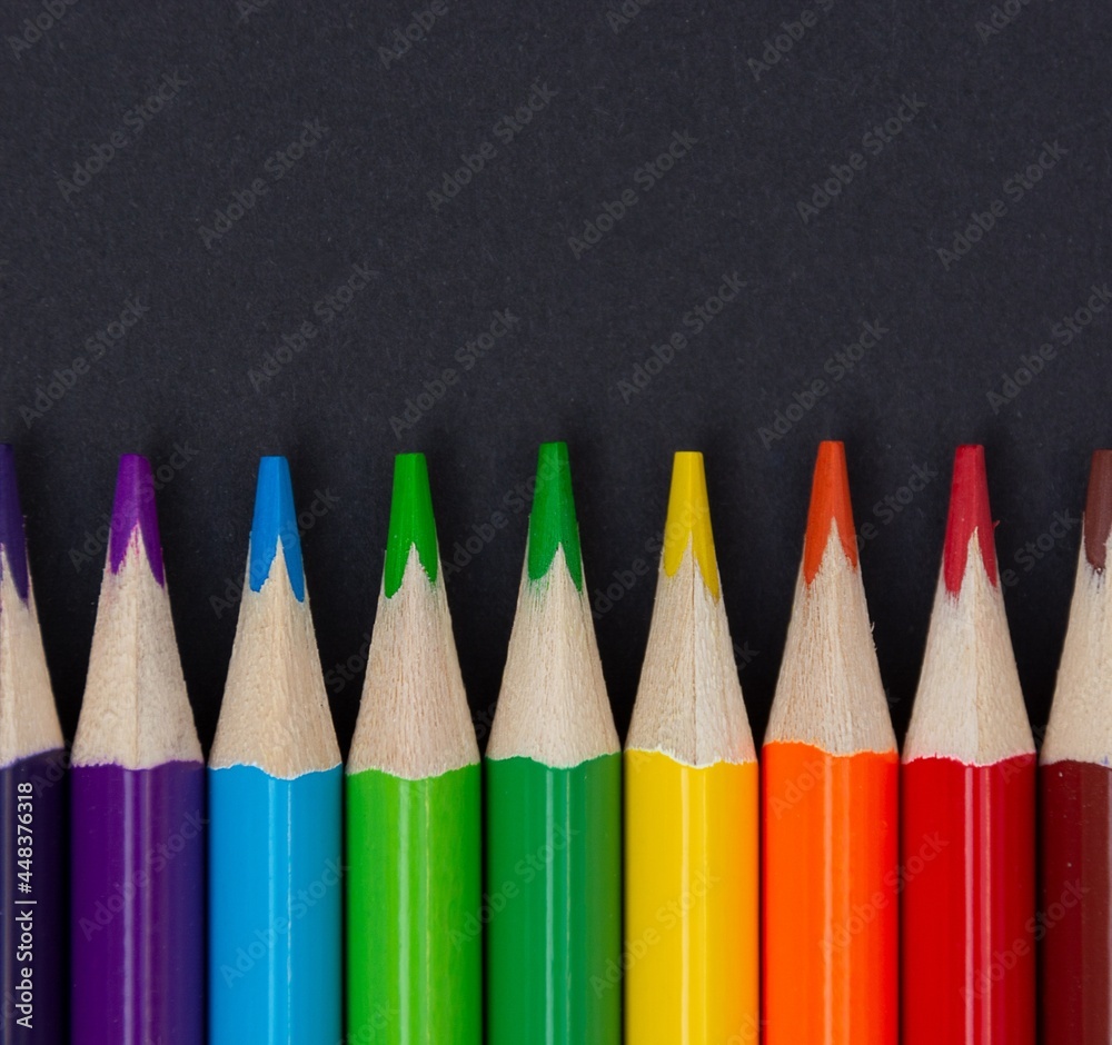 Close-up of colored pencils on blackboard background Close-up of colored pencils on blackboard background